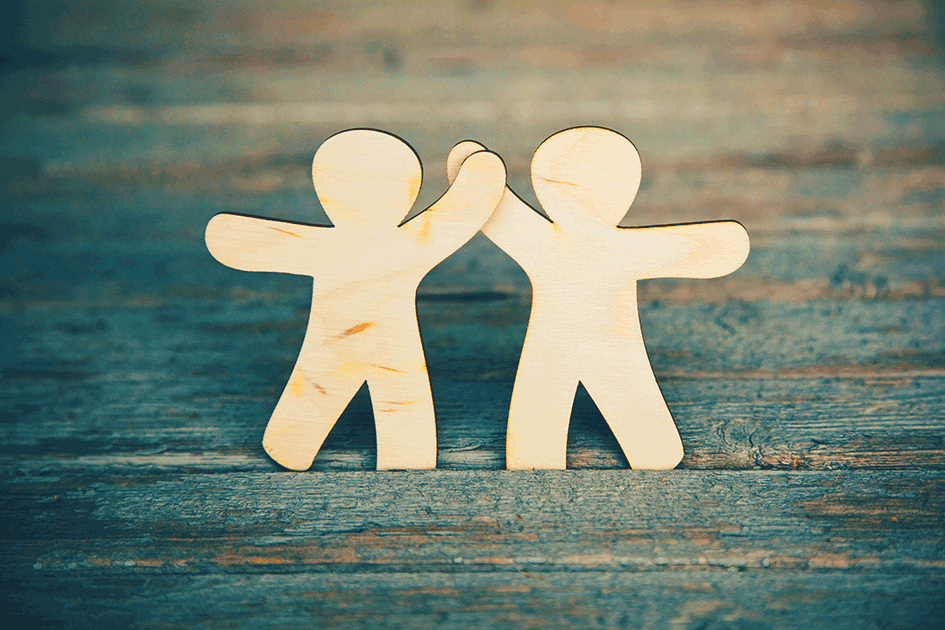 image of two cutout figures high-fiving demonstrating team work