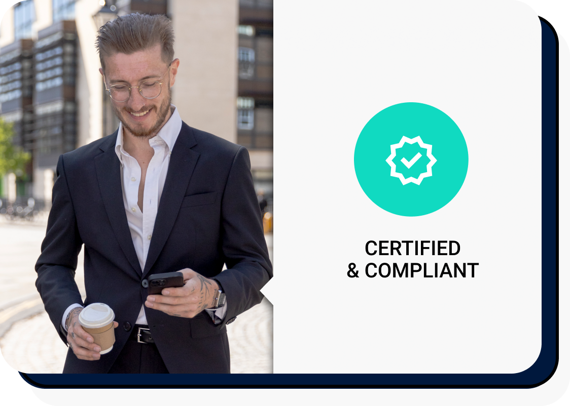 A man in a suit walking through the city on his phone