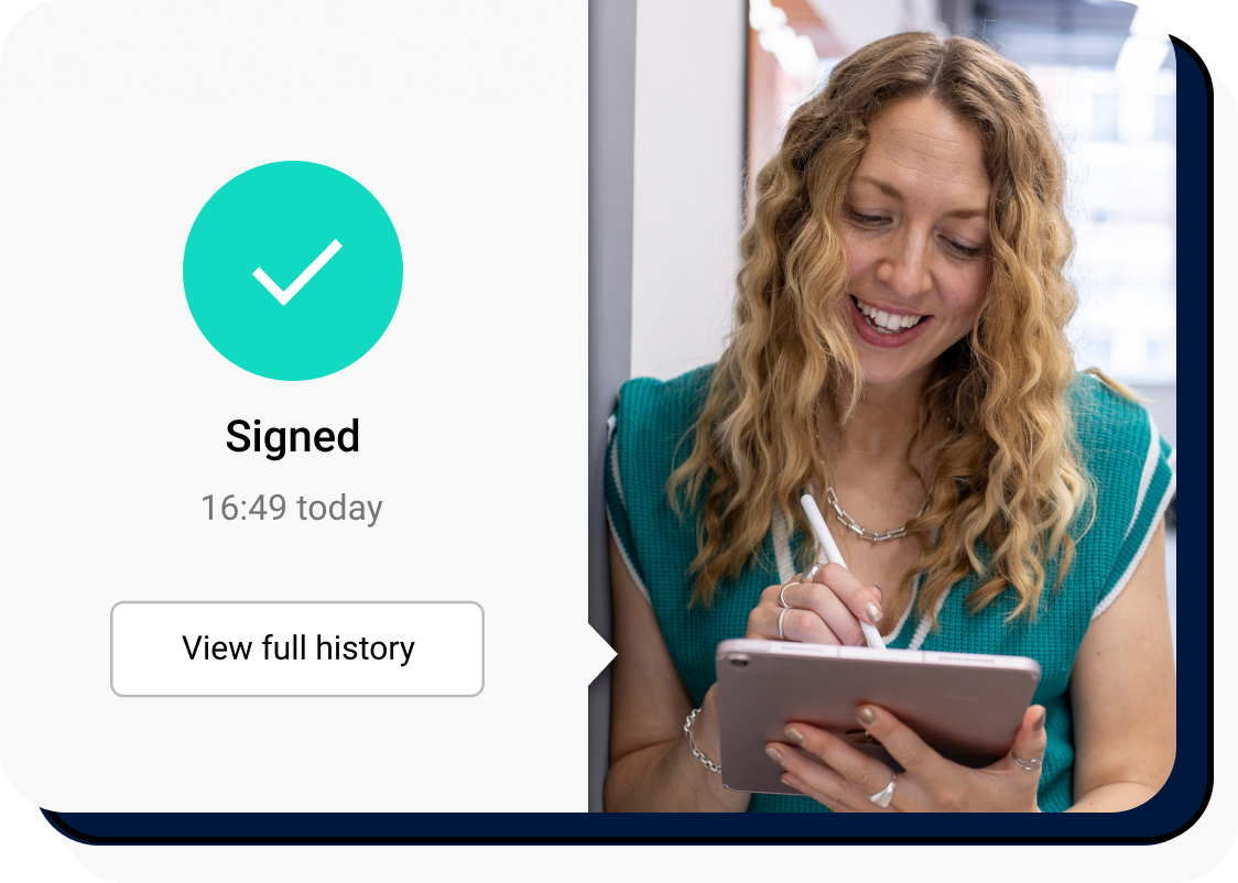 A woman smiling at an ipad whilst signing electronically