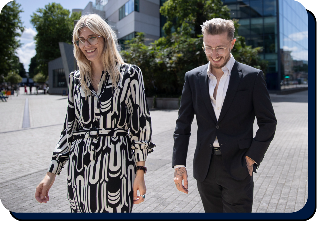 graphic_real_estate Professional man in suit and woman in printed dress walking in the city