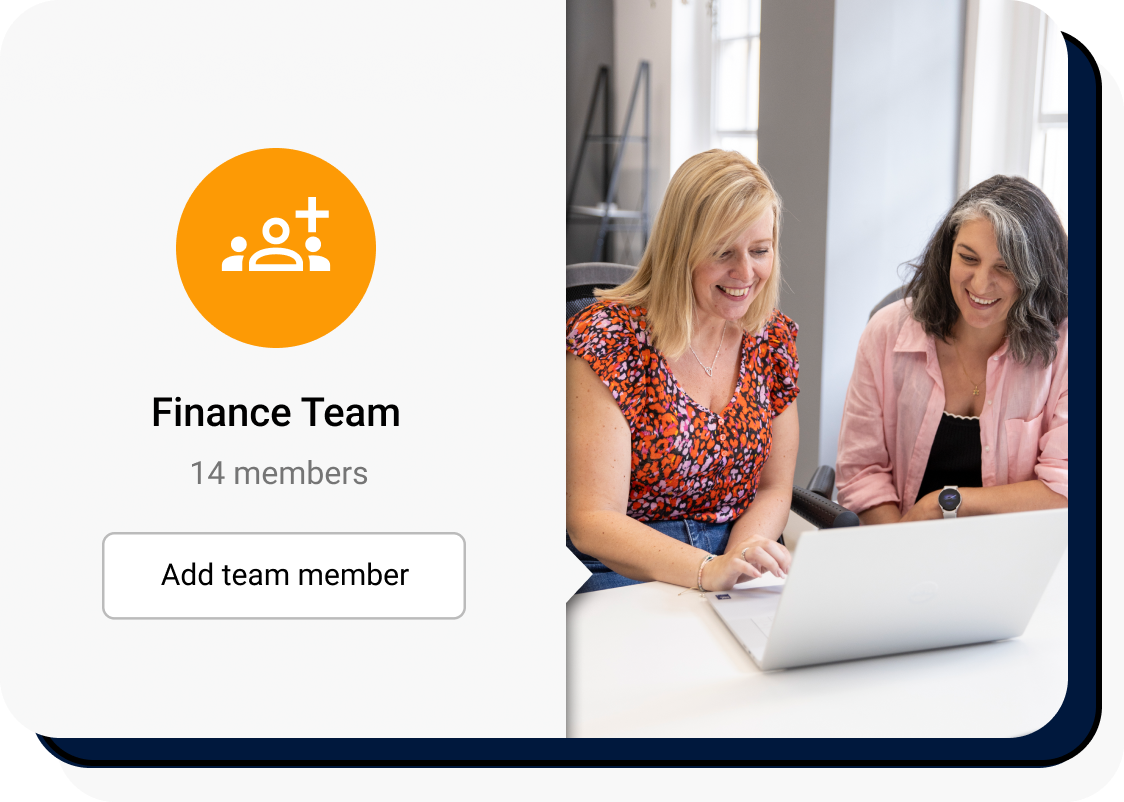 Two women looking at a laptop in a bright and airy office
